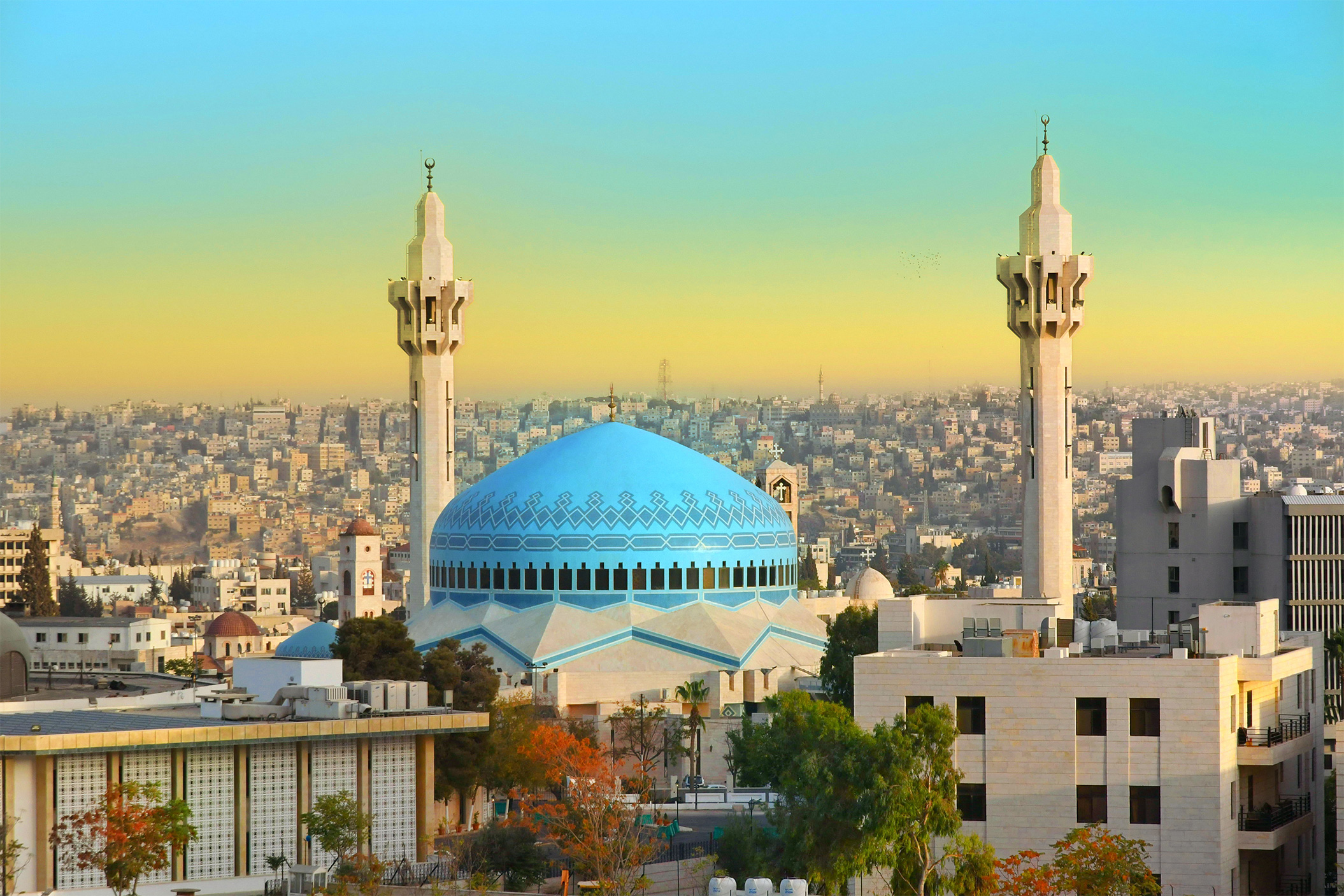 The Striking Blue Dome Of King Abdullah I Mosque Standing Gracefully Against Amman’S Hillside Skyline