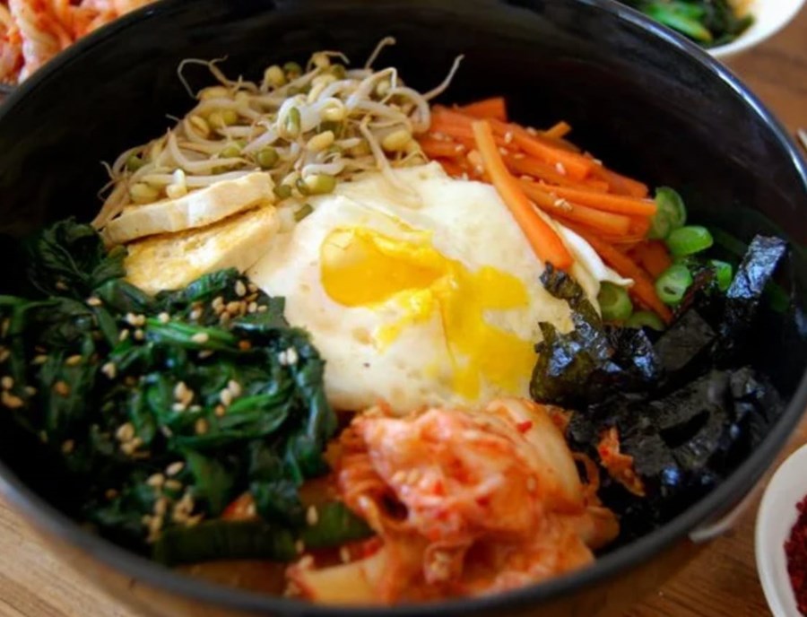 Enjoy Traditional Bibimbap, A Colourful And Comforting Korean Dish Filled With Fresh Vegetables, Rice And Bold Flavours