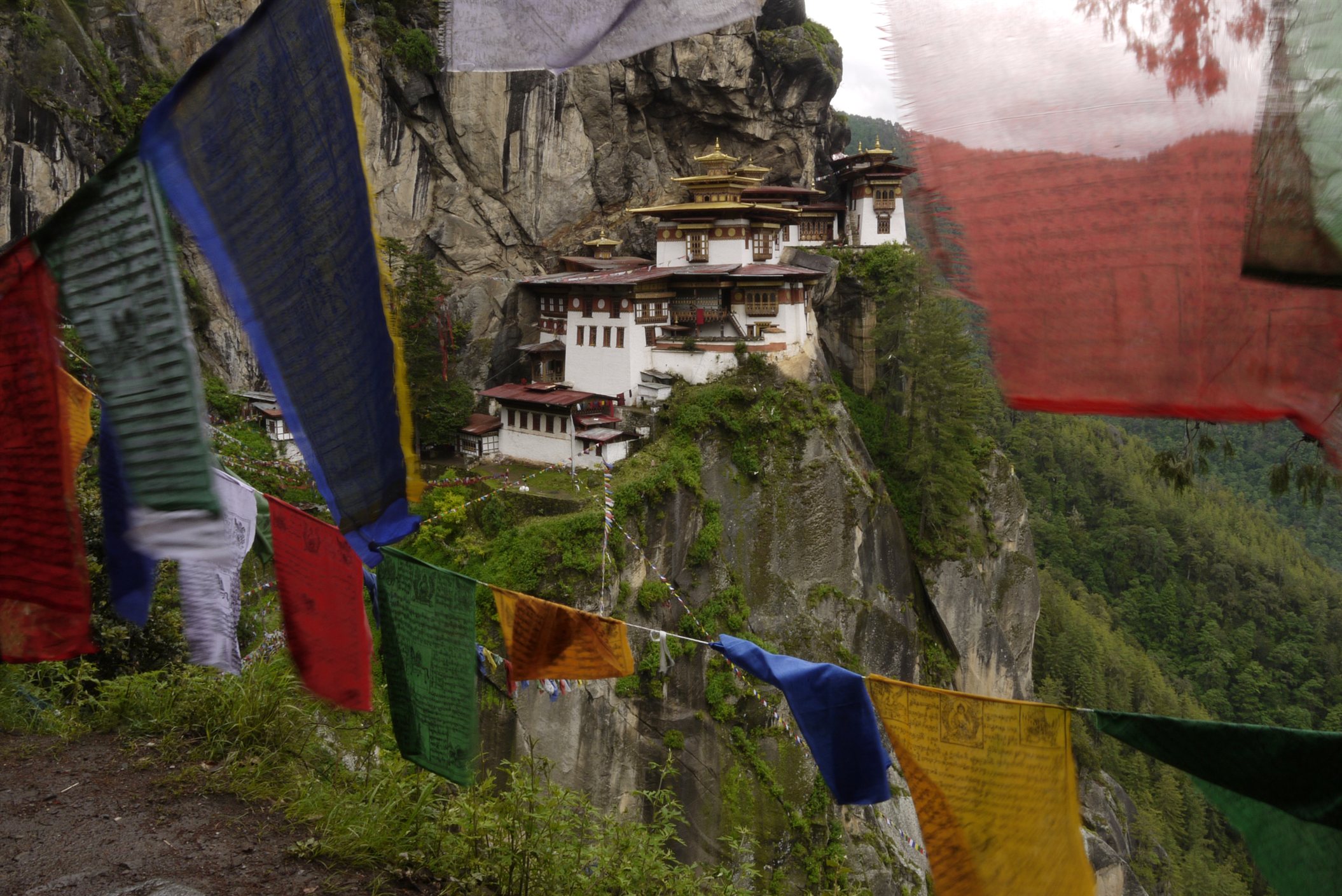 Prayer flags flutter along the mountain trail