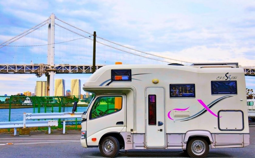 Campervan driving through Japan’s countryside on a scenic road trip