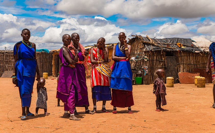 Maasai women in traditional dress communicate with each other in Kenya