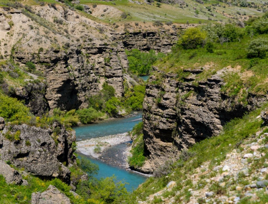 Discover Aksu Canyon, Where Dramatic Cliffs Plunge Towards The Winding Turquoise Waters Of The Aksu River