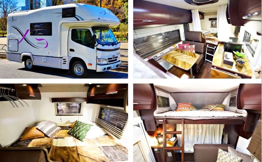 Interior of a middle-class campervan in Osaka, Japan, showing seating, kitchen, and sleeping arrangements.
