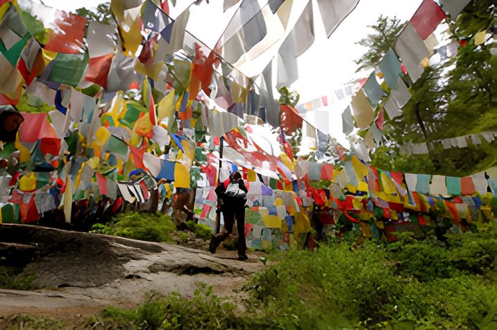 Mebar Tsho (Burning Lake) in Bhutan, surrounded by colorful prayer flags
